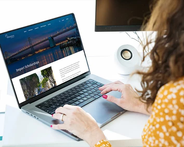 young woman smiling at computer