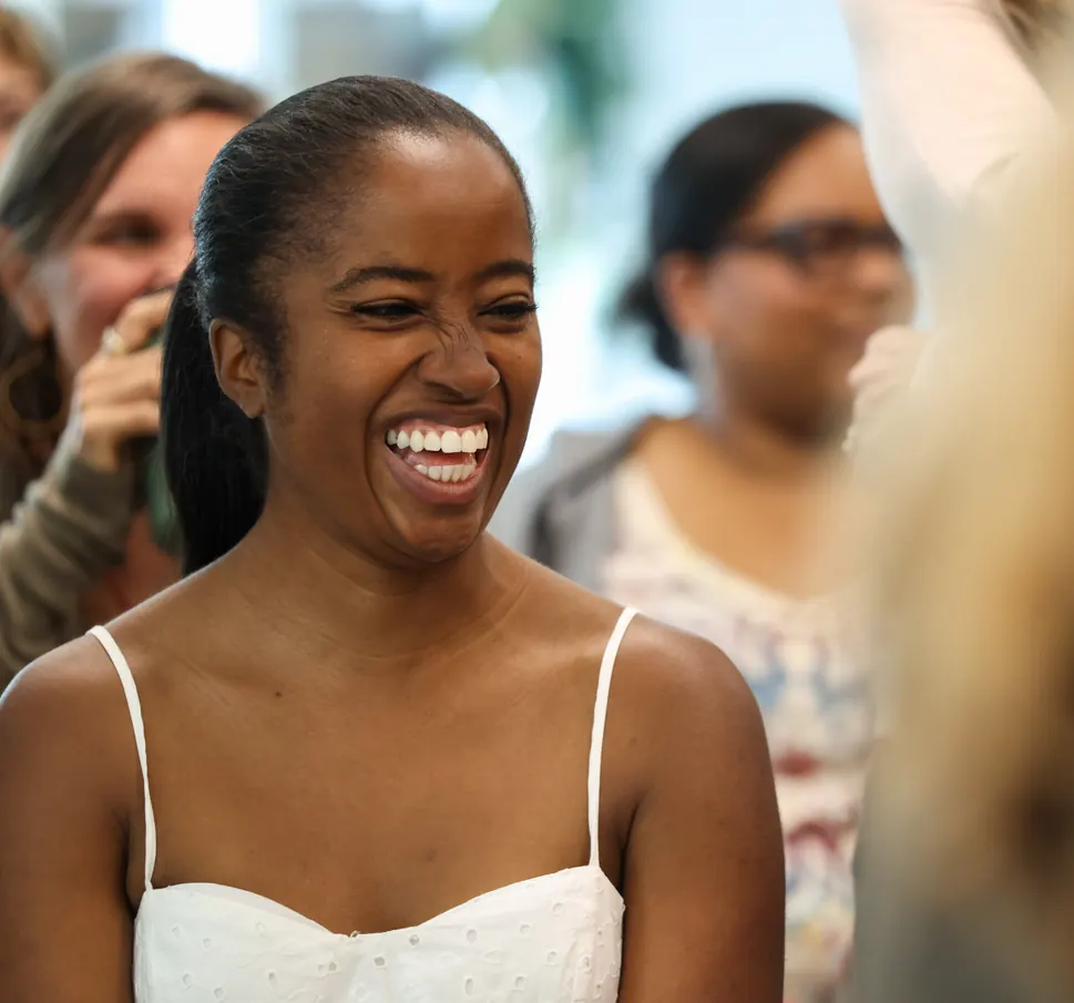A participant laughs with the group at a Meridian Transformative Learning Lab