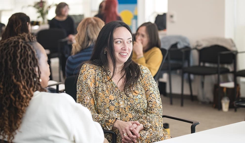 A student smiles during a group discussion in a Meridian classroom
