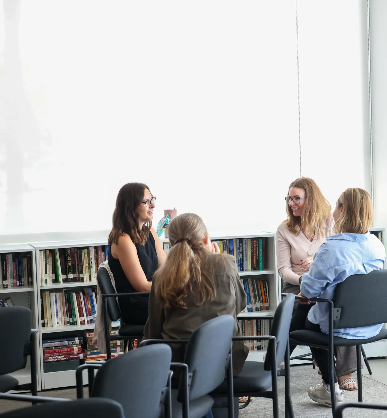 Small groups in conversation around the room at a Meridian Transformative Learning Lab