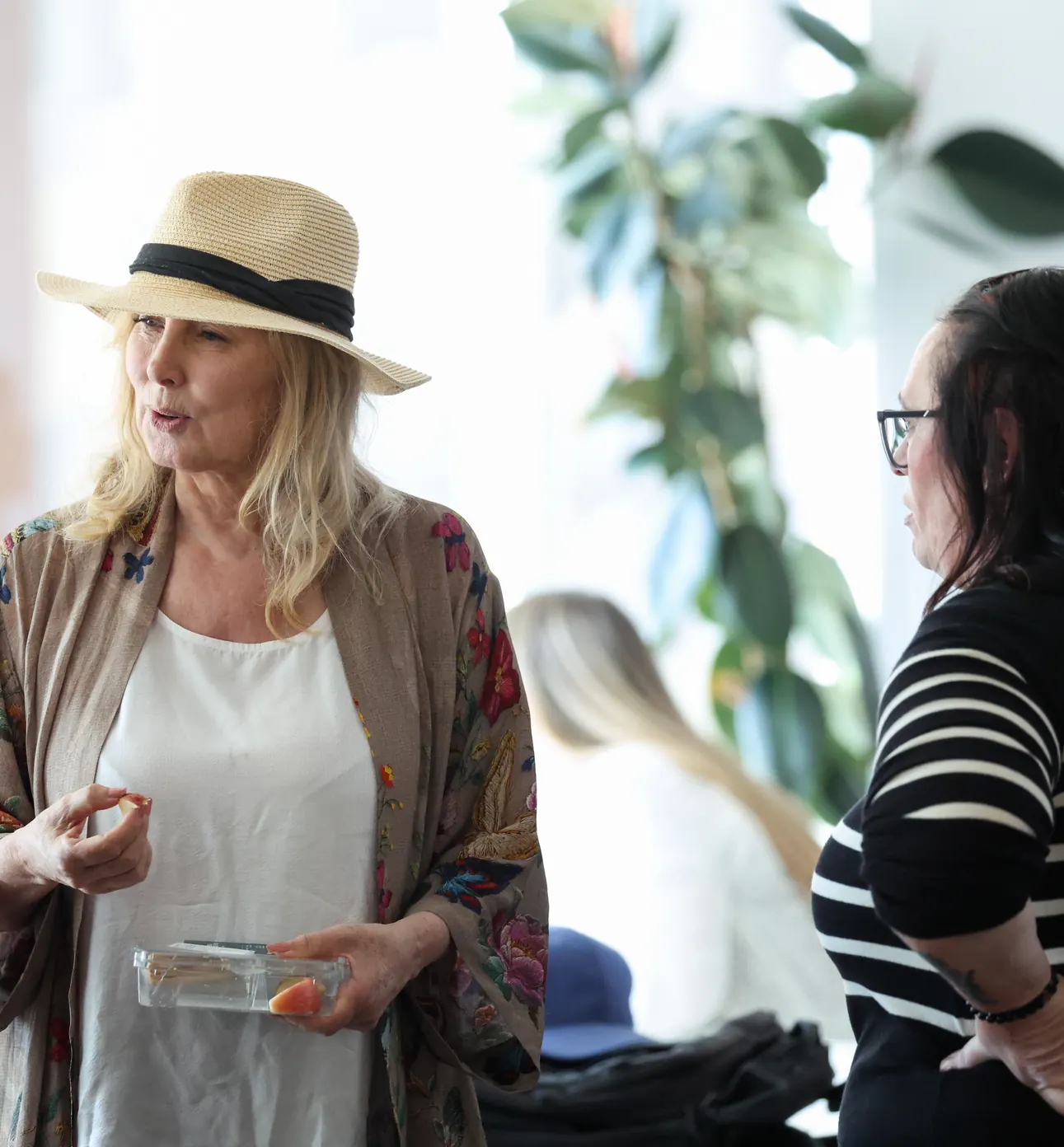 A participant talks with others between sessions at a Meridian Transformative Learning Lab