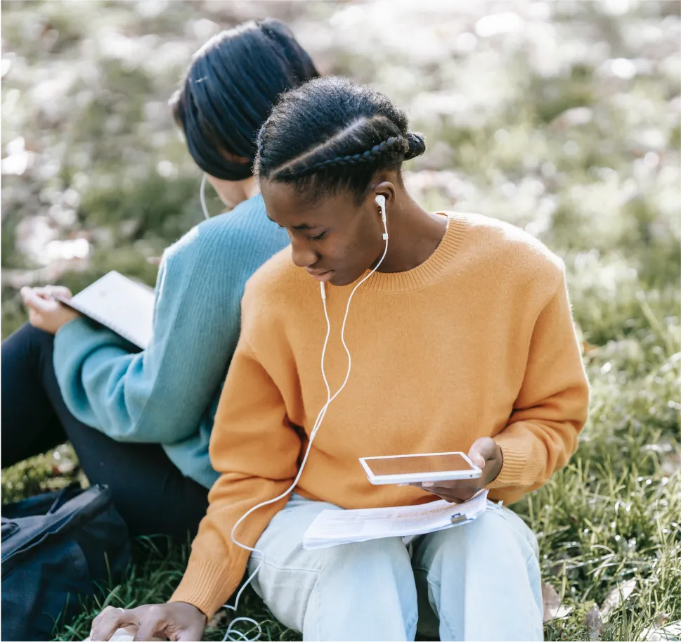 people sitting outside on devices