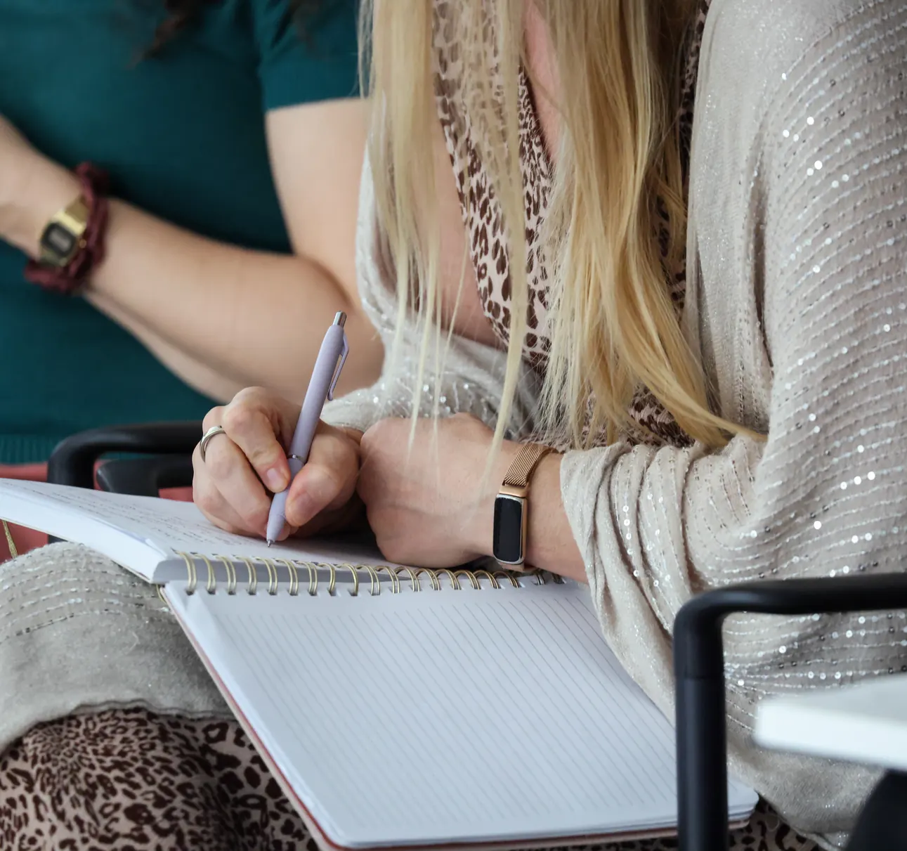 A participant takes notes in a notebook at a Meridian Transformative Learning Lab