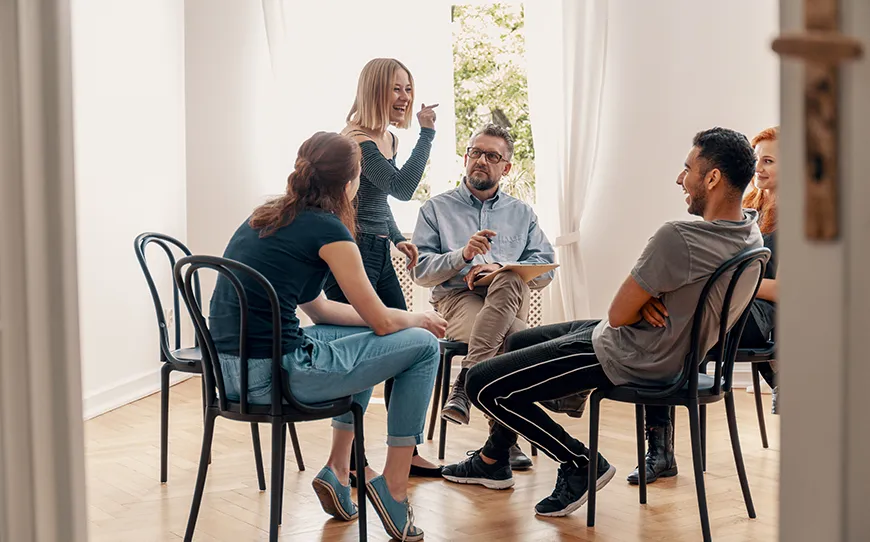A group of diverse MBA students engaged in a collaborative discussion during a leadership seminar.