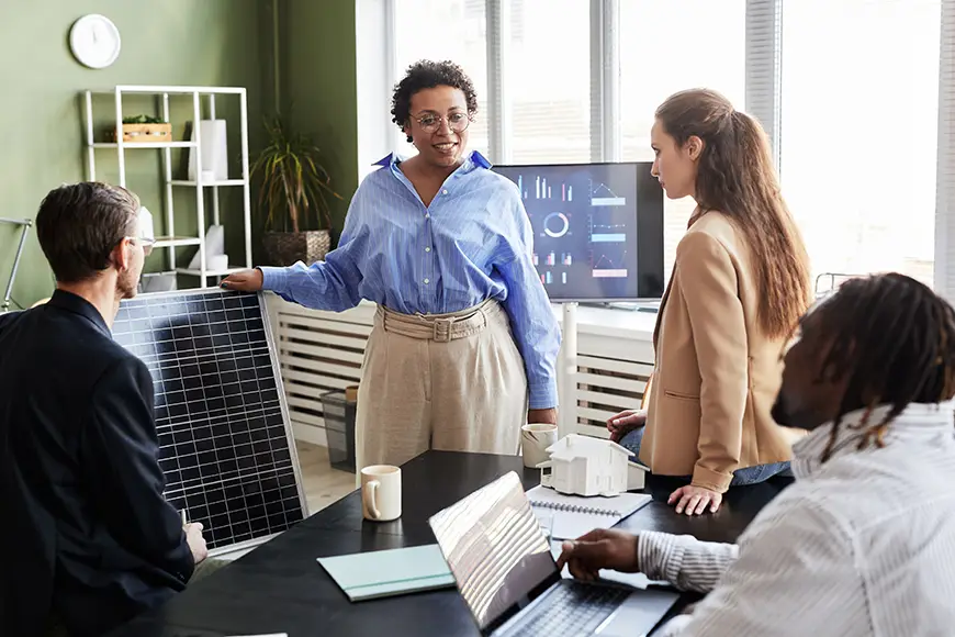 A woman presenting alternative energy to a group of 3.