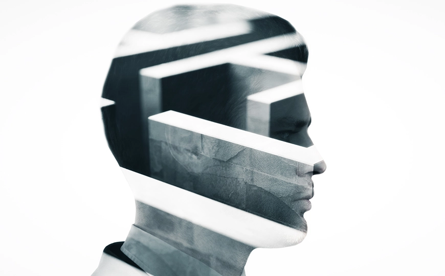 An illustration of a translucent silhouette of a human head filled with a maze of corridors.