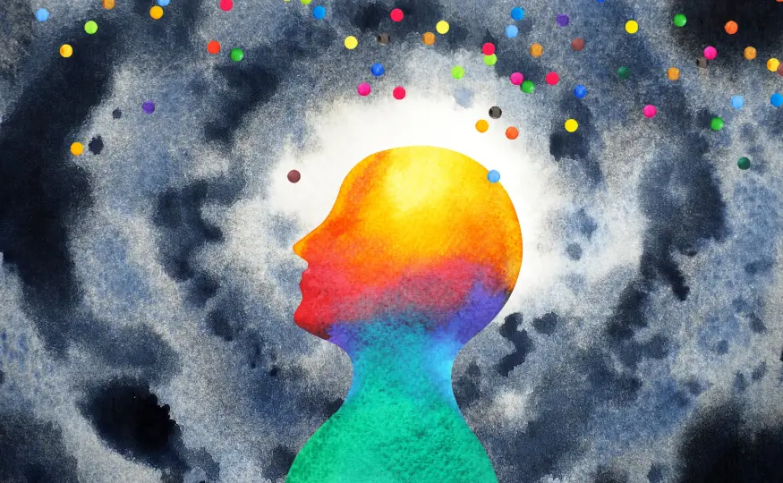 A colorful human silhouette emerging from a dark, star-like background.