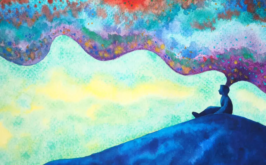 A silhouetted person sits on a blue hill beneath a colorful abstract sky.